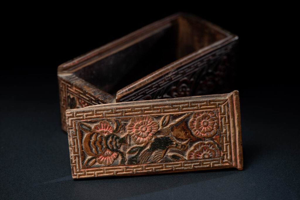 Ancient Pingpu Tribes wooden box with a sliding lid carved with the typical Pingpu tribe flower pattern and paint with red and black pigments.