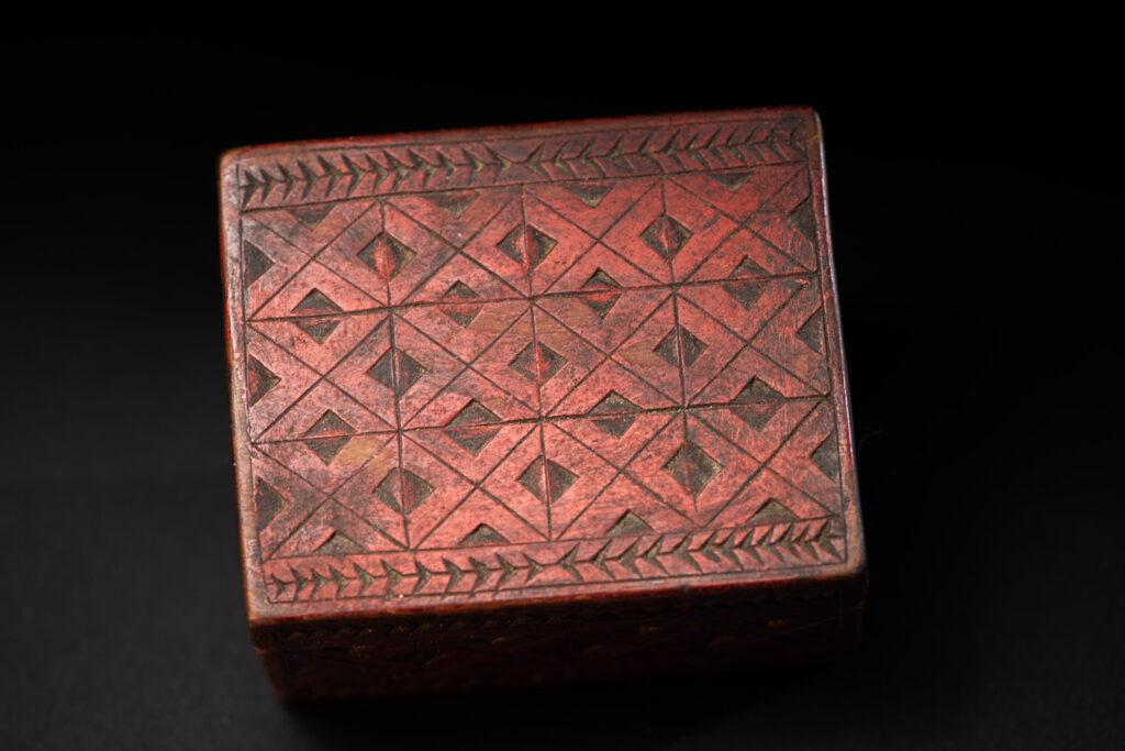 Paiwan tribe wooden Box paint with red pigments with geometrical patterns.