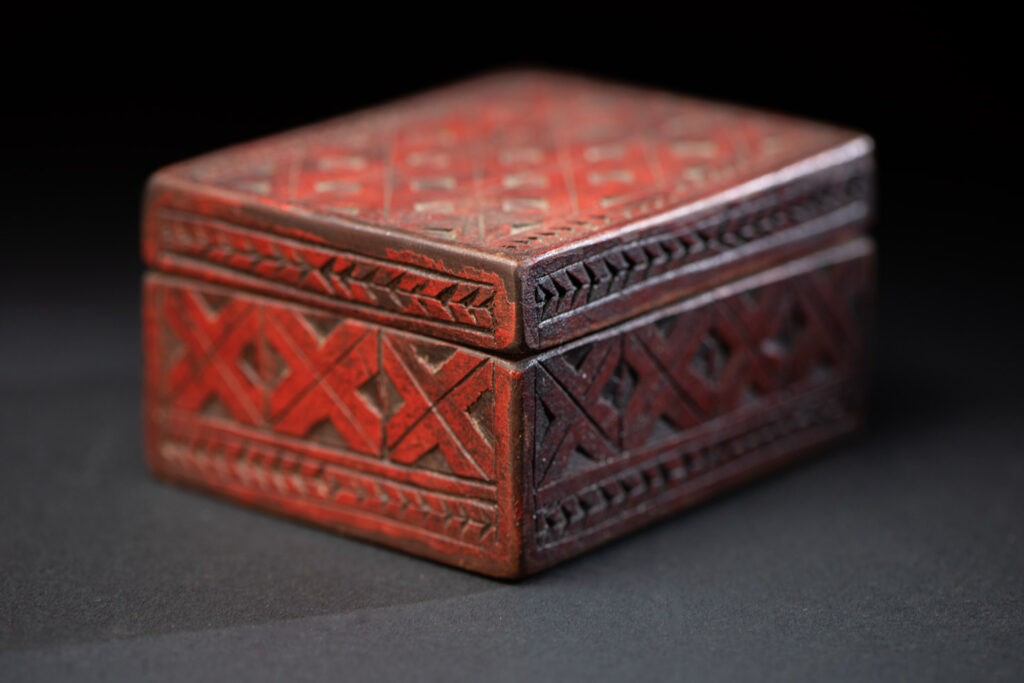 Paiwan tribe wooden Box paint with red pigments with geometrical patterns.