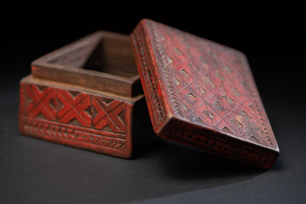 Paiwan tribe wooden Box paint with red pigments with geometrical patterns.