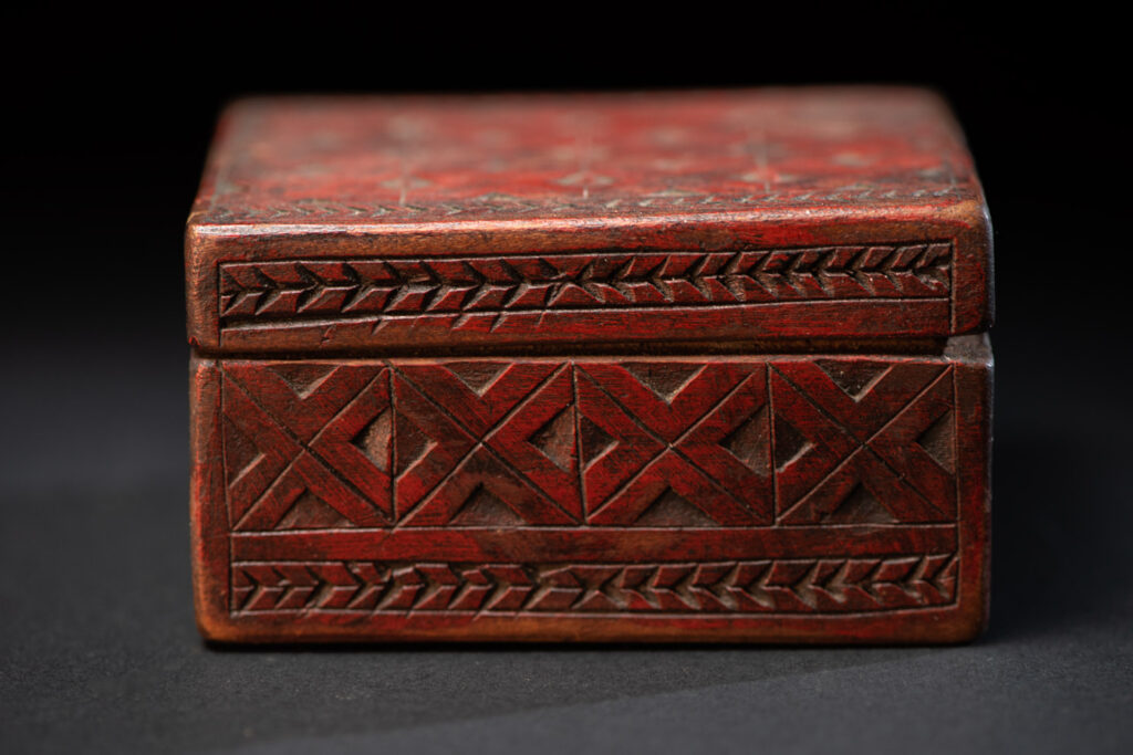 Paiwan tribe wooden Box paint with red pigments with geometrical patterns.
