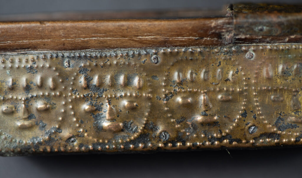 This great sword from the Paiwan tribe is decorated with embossed brass engraved with faces on the front and the side while the back is carved with three characters in the pure Paiwan style.