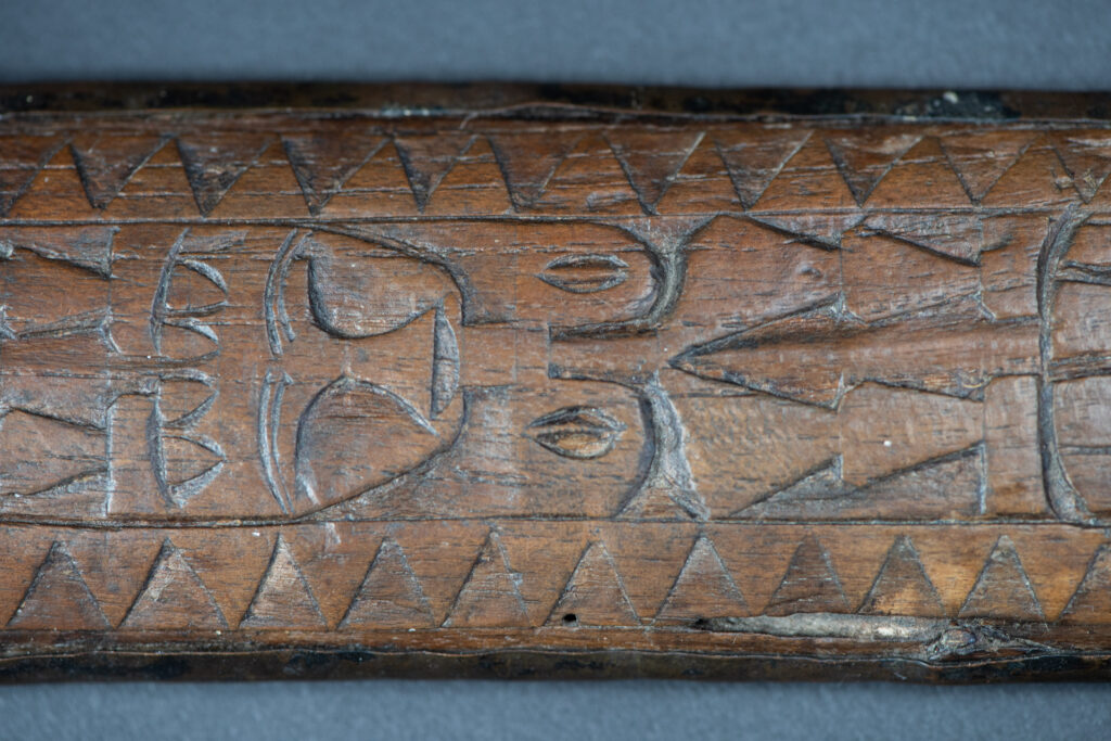 This great sword from the Paiwan tribe is decorated with embossed brass engraved with faces on the front and the side while the back is carved with three characters in the pure Paiwan style.