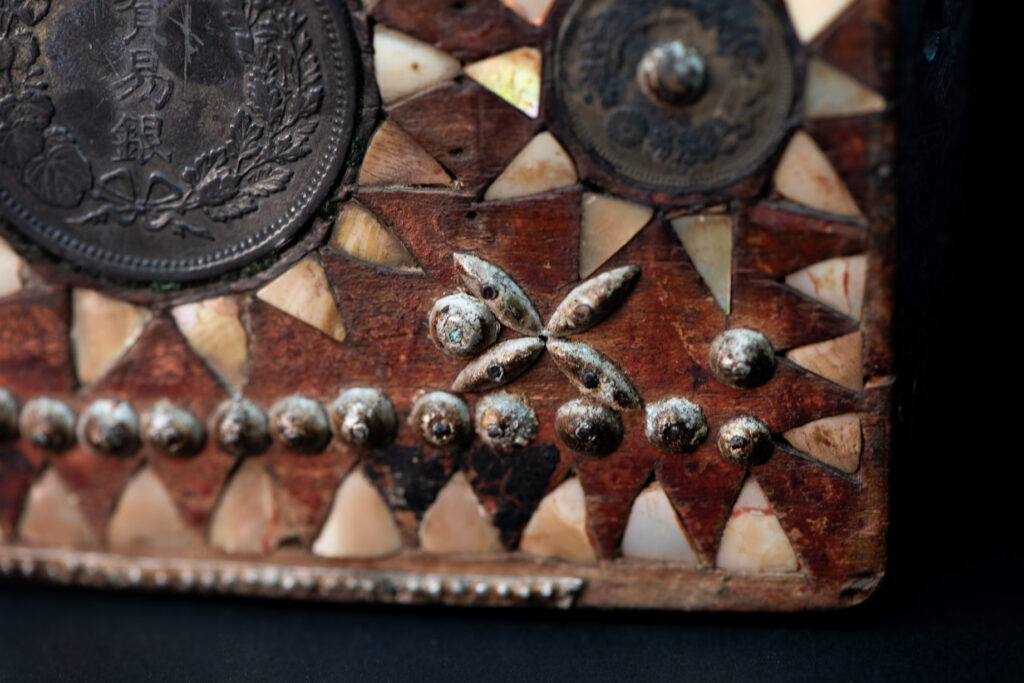 Old shaman’s box – Puyuma tribe – inlaid with mother-of-pearl in triangular patterns, reflecting the distinctive style of the Puyuma tribes. The box is also decorated with embedded old coins.