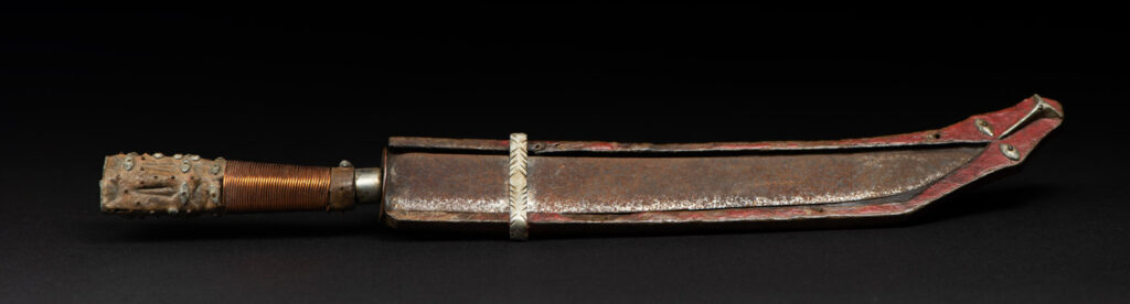 Paiwan tribe knife with the sheath paint in red . The handle is wrapped with copper string