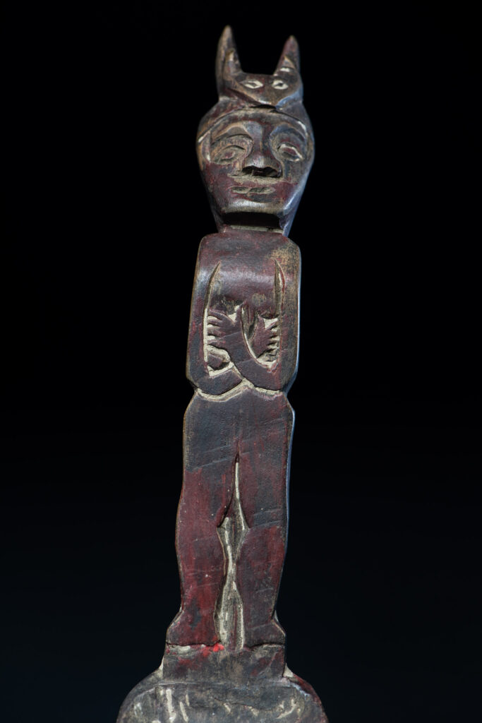 Old spoon from the Paiwan tribe, tinted with red pigments and depicting an ancestor wearing a ceremonial headdress.