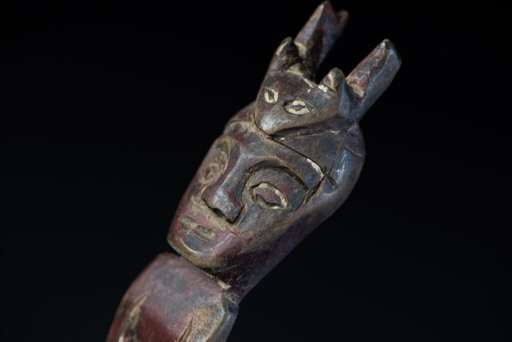 Old spoon from the Paiwan tribe, tinted with red pigments and depicting an ancestor wearing a ceremonial headdress.