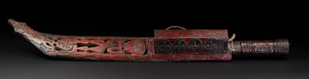 Paiwan tribe ancient sword painted in red, carved with standing figures and humain faces on the side.