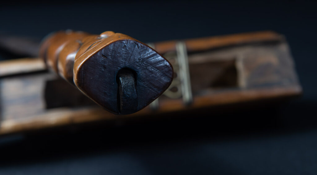 Very fine sword from the Paiwan tribe, carved with the sacred snake and human faces along the sides. The hilt features a full-length standing figure.