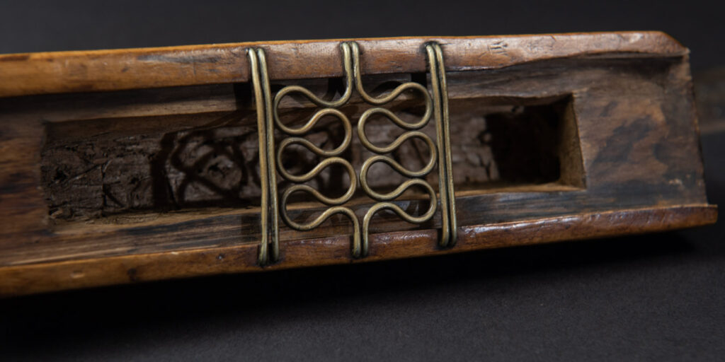 Very fine sword from the Paiwan tribe, carved with the sacred snake and human faces along the sides. The hilt features a full-length standing figure.
