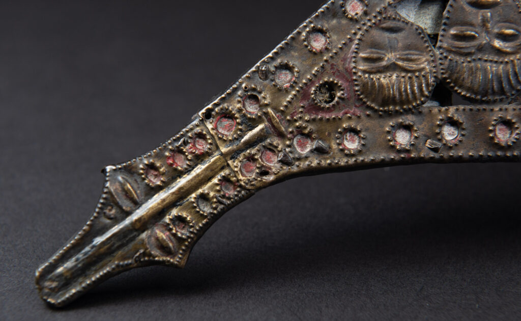 Paiwan tribe ancient sword painted in red, carved with standing figures and humain faces on the side.