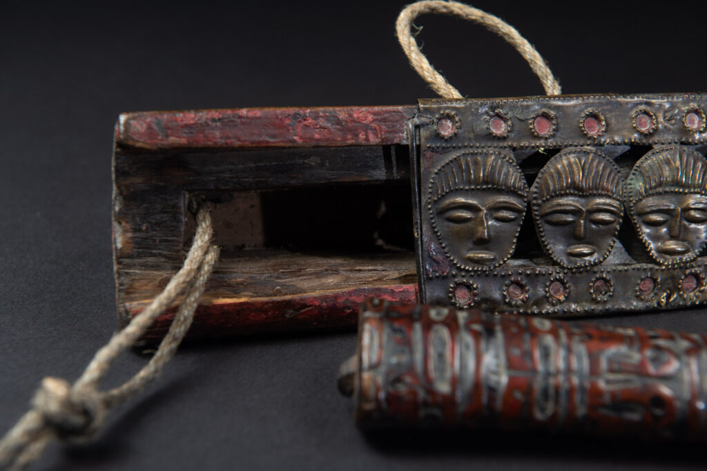 Paiwan tribe ancient sword painted in red, carved with standing figures and humain faces on the side.
