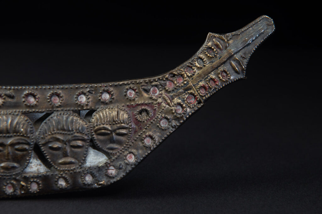 Paiwan tribe ancient sword painted in red, carved with standing figures and humain faces on the side.