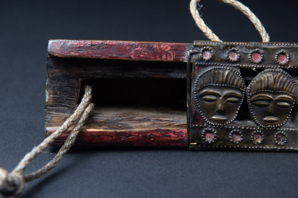 Paiwan tribe ancient sword painted in red, carved with standing figures and humain faces on the side.