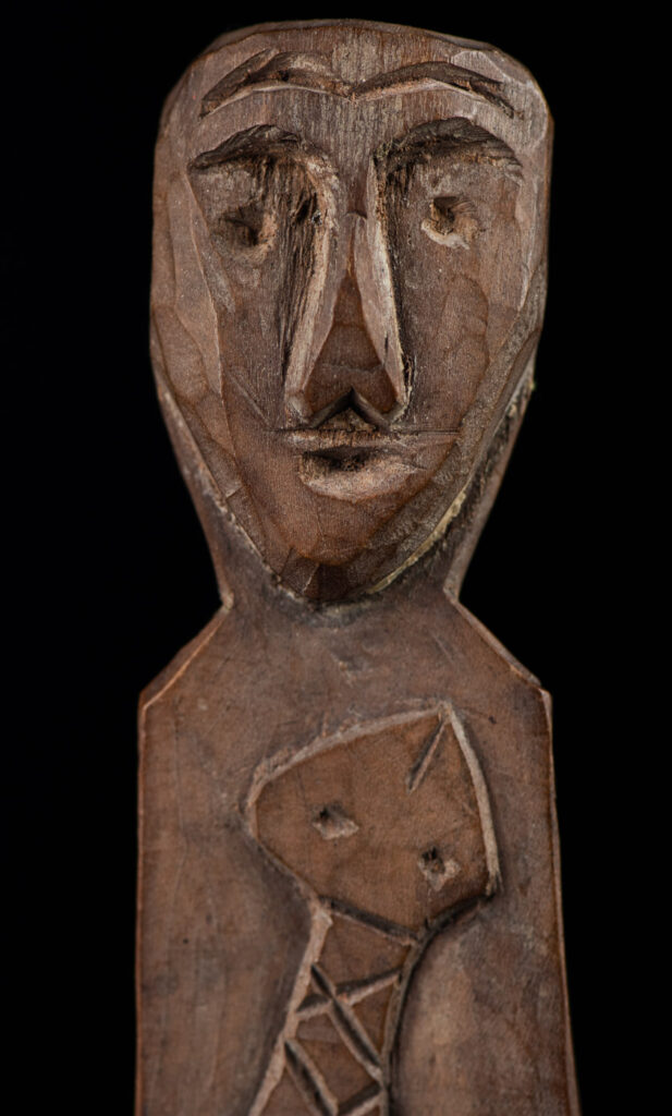 Old wooden spoon from the Paiwan tribe, carved with a one hundred pace snake at the back and one human head and sacred snake at the front.