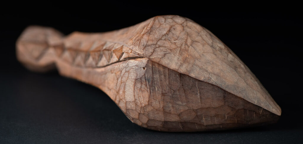 Old wooden spoon from the Paiwan tribe, carved with a one hundred pace snake at the back and one human head and sacred snake at the front.