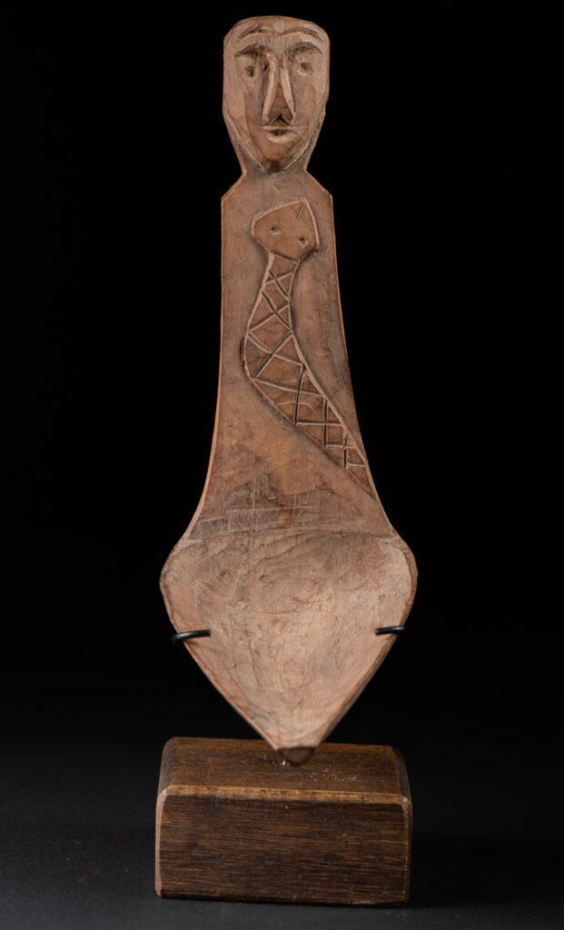 Old wooden spoon from the Paiwan tribe, carved with a one hundred pace snake at the back and one human head and sacred snake at the front.