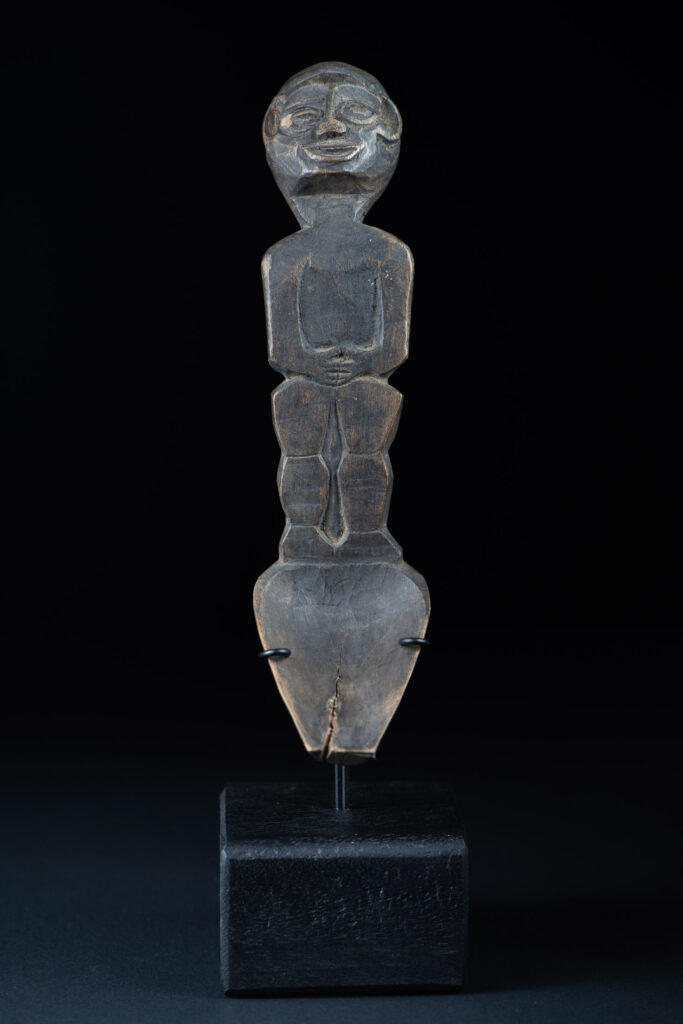 Old wooden spoon from the Paiwan tribe, carved with a standing figure .