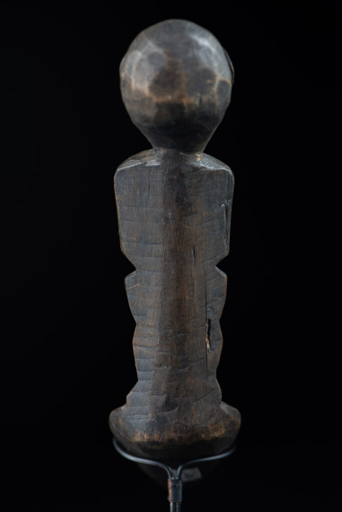Old wooden spoon from the Paiwan tribe, carved with a standing figure .