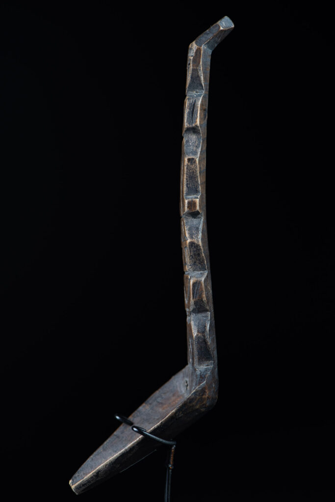 Old wooden spoon from the Paiwan tribe, carved with a standing figure .