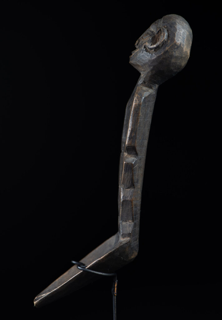 Old wooden spoon from the Paiwan tribe, carved with a standing figure .