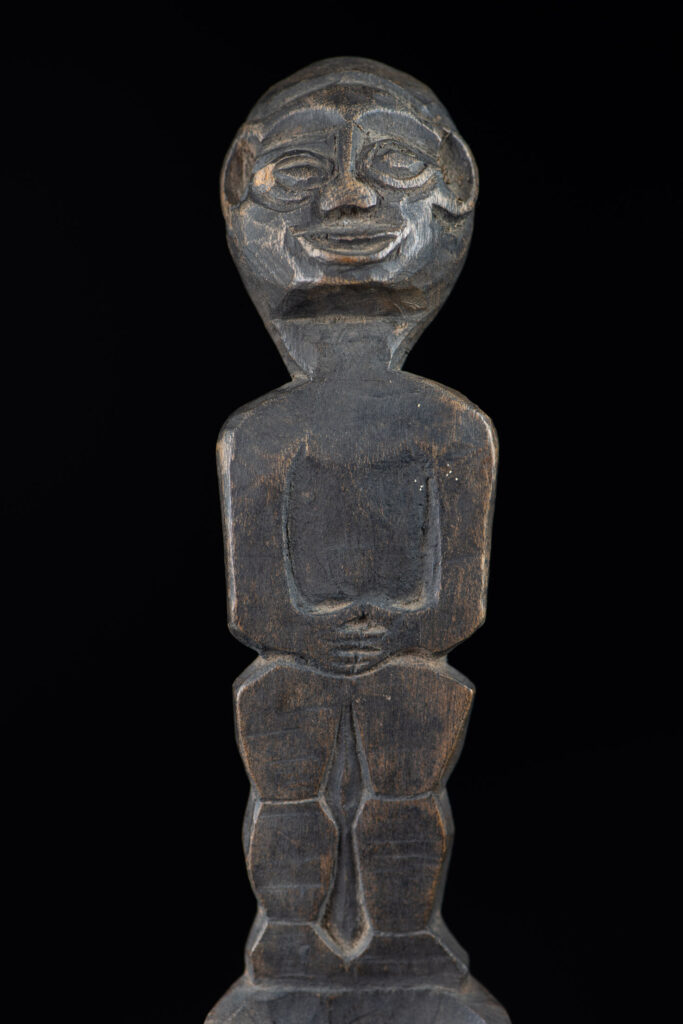 Old wooden spoon from the Paiwan tribe, carved with a standing figure .