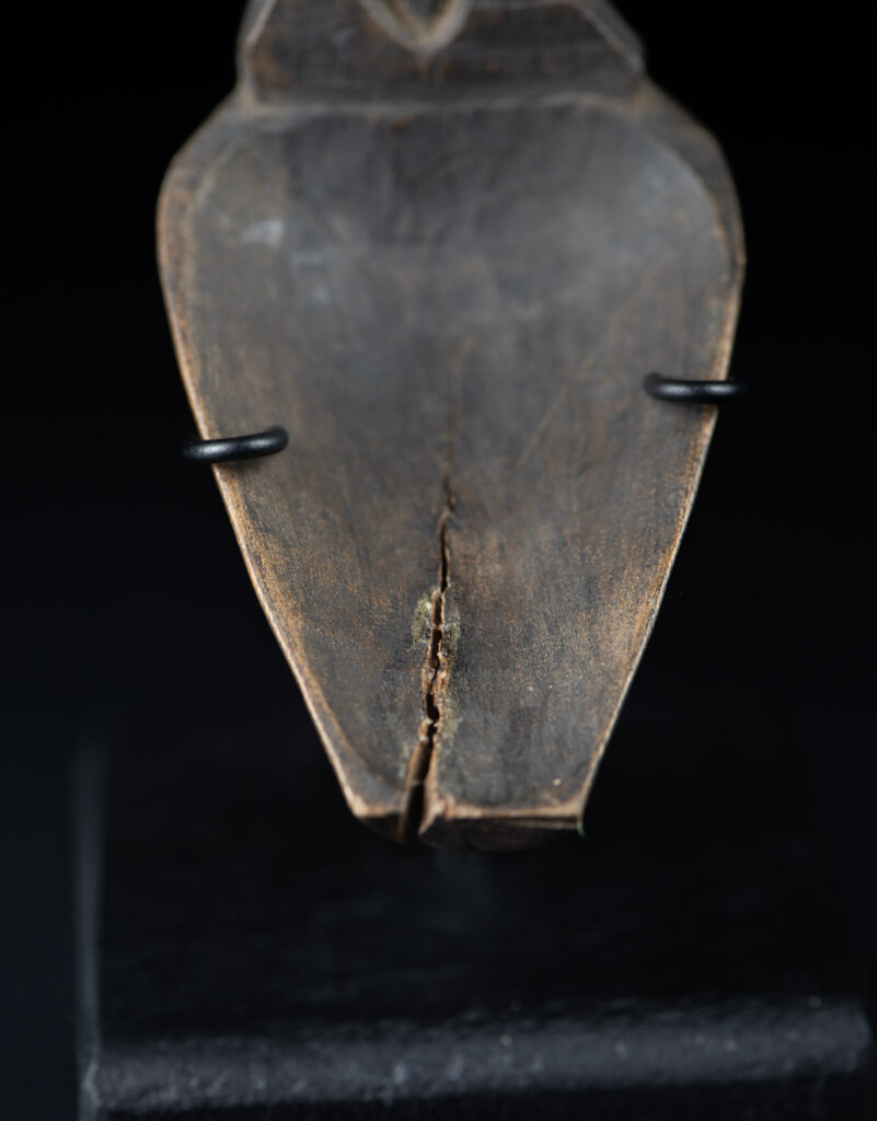 Old wooden spoon from the Paiwan tribe, carved with a standing figure .