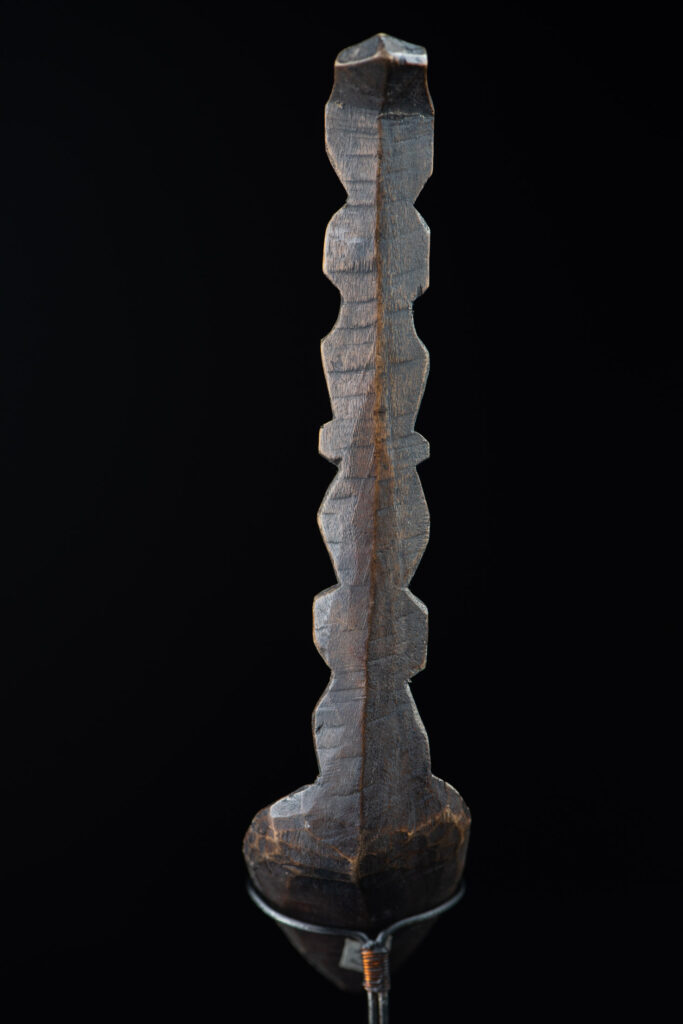Old spoon from the Paiwan tribe, carved with two full-length standing figures, one above the other.