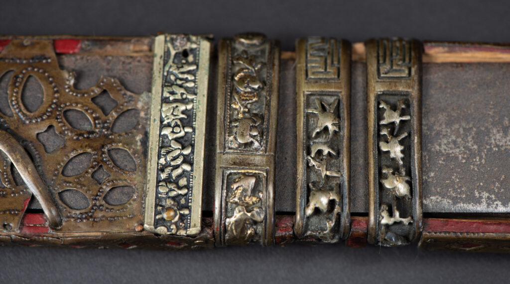 ancient ceremonial Rukai tribe sword paint in red in a typical Rukai tribe style. Ancient ceremonial long sword from the Rukai tribe. The back of the sheath is painted red and inlaid with finely engraved snakes in brass sheet. The top is also covered with an engraved brass plate. The very long blade of this Rukai sword features a handle in the Rukai style, decorated with small flower-shaped motifs and aluminum wire. The guard of the sword is made from a Japanese coin.