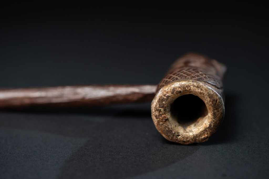 Very fine pipe from the Paiwan tribe, carved on both sides with human faces representing Paiwan warriors. The interior of the bowl is lined with aluminum.