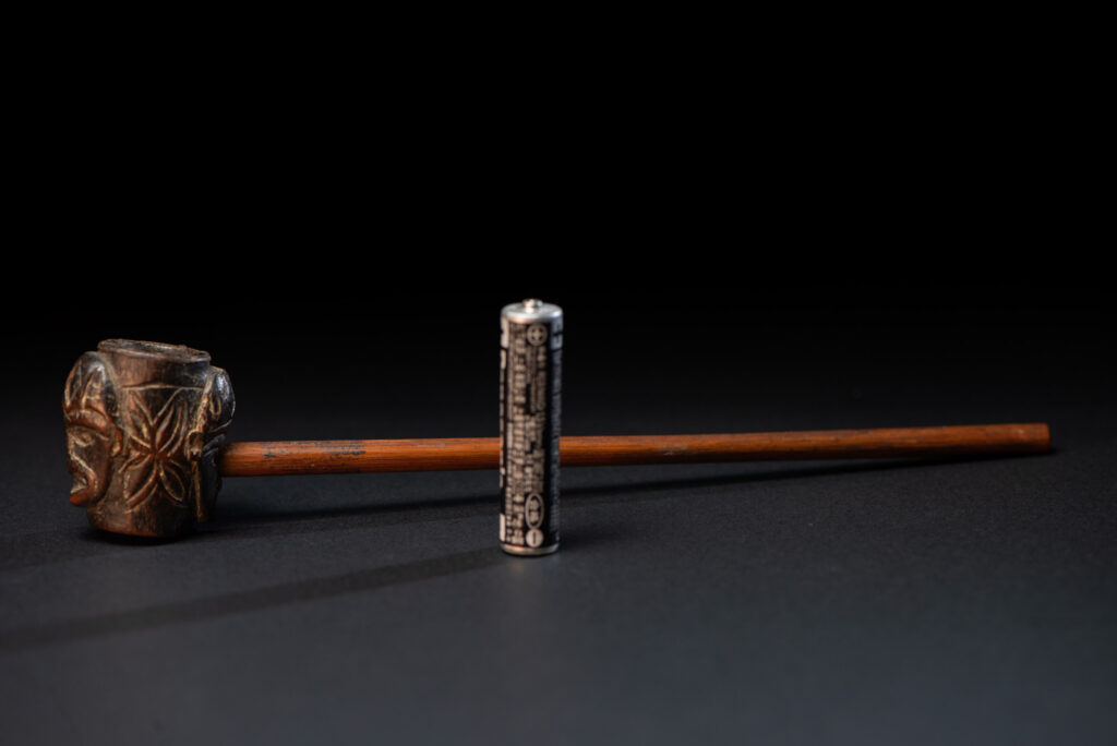 Very ancient fine pipe made of precious wood from the Paiwan tribe, carved with human faces representing a Paiwan warriors on the front and the back.