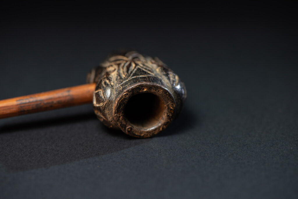 Very ancient fine pipe made of precious wood from the Paiwan tribe, carved with human faces representing a Paiwan warriors on the front and the back.