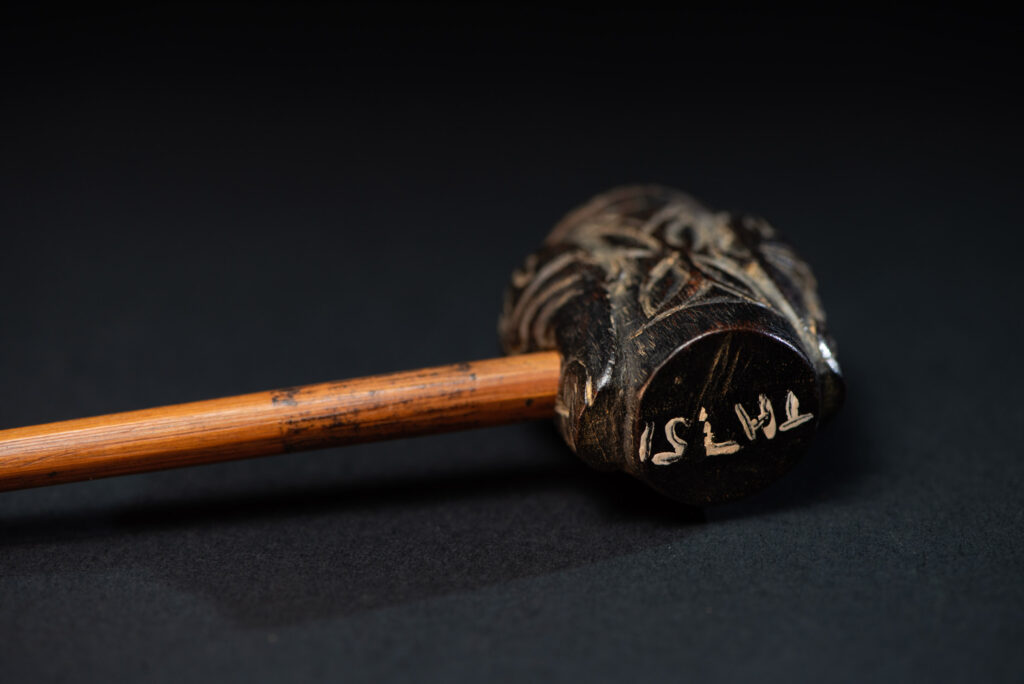 Very ancient fine pipe made of precious wood from the Paiwan tribe, carved with human faces representing a Paiwan warriors on the front and the back.
