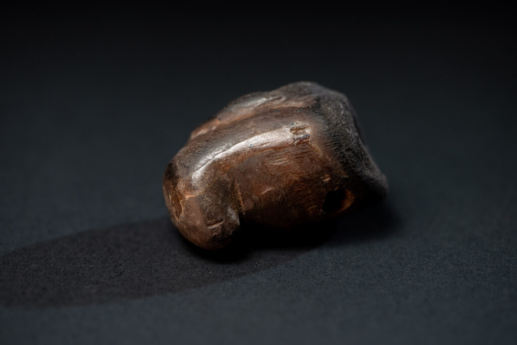 Paiwan tribe pipe bowl carved with a human face.