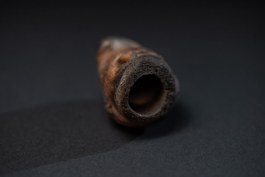 Paiwan tribe pipe bowl carved with a human face.
