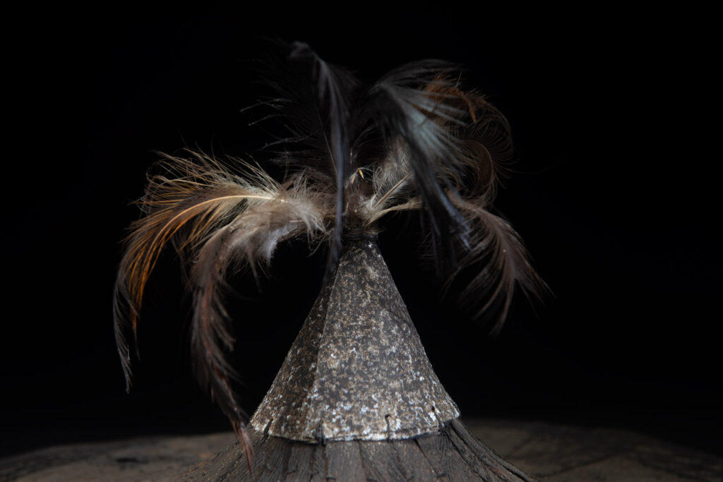 This ancient hat from the Yami- Tao tribes, orchid Island, Taiwan was worn by the female for work in the fields It is named “Varogot”. It is done with coconut palm bark, rotaing, aluminium and feathers for the top decoration..