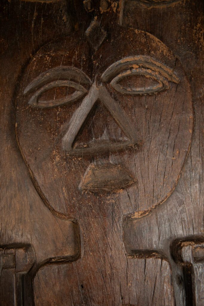 Very beautiful and massive ancestral panel from the Paiwan tribe, dating from the 19th century, carved with a nude female ancestor wearing a headdress formed by two intertwined snakes facing away from each other. A truly remarkable piece.