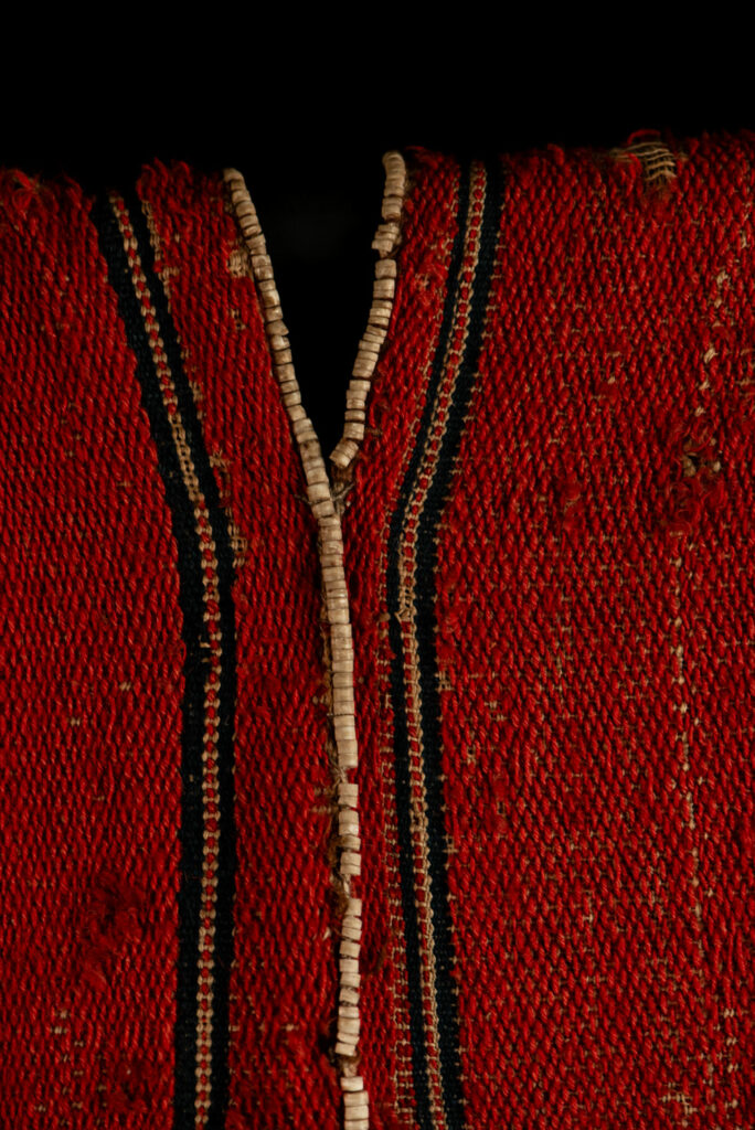 19 century Long men's jacket from the Atayal tribe, entirely woven in red with black and white stripes, and adorned with bone beads along the edges.