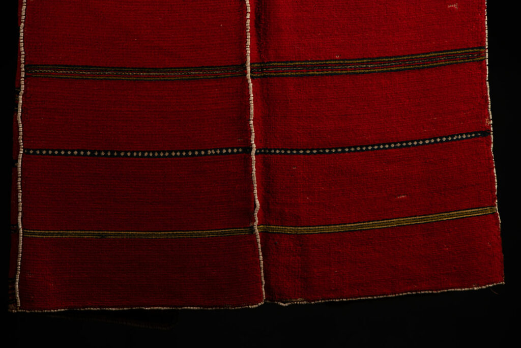 19 century Long men's jacket from the Atayal tribe, entirely woven in red with black and white stripes, and adorned with bone beads along the edges.