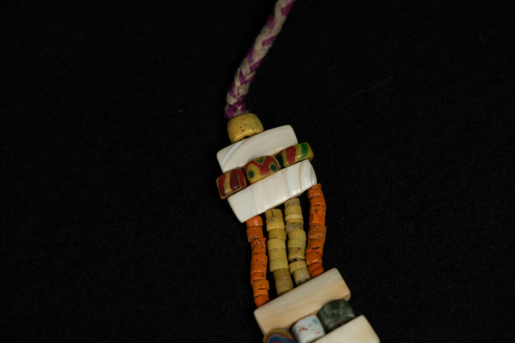 Paiwan tribe old Glass beads collar In Paiwan society, ancient and valuable glass beads are treasured as heirlooms or betrothal gifts, symbolizing aristocratic status. These beads are often carefully stored in old pottery jars.