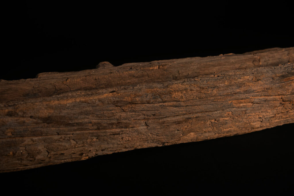 19th-century door lintel from the Paiwan tribe, carved with a pair of snakes facing each other and two human faces on either side. This Paiwan panel is heavily eroded and was probably placed above the entrance, exposed to the elements.
