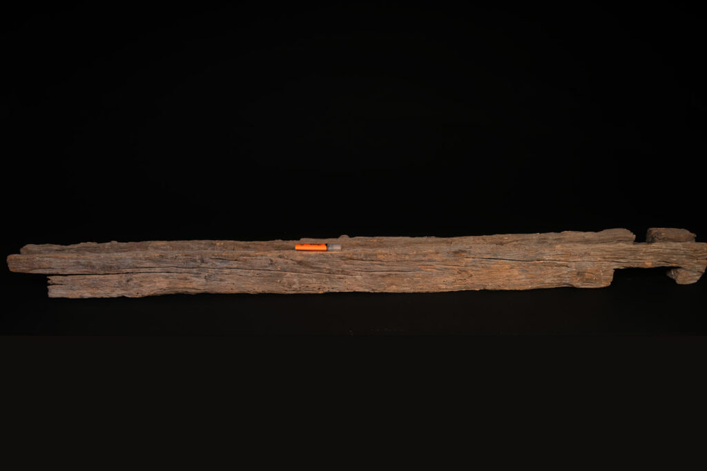 19th-century door lintel from the Paiwan tribe, carved with a pair of snakes facing each other and two human faces on either side. This Paiwan panel is heavily eroded and was probably placed above the entrance, exposed to the elements.