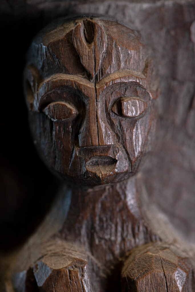 Small ancient mortar from the Paiwan tribe, richly carved around its circumference with a chain of crouching Paiwan figures.