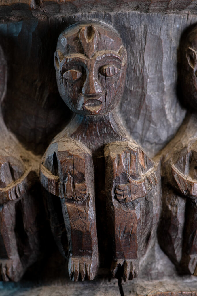 Small ancient mortar from the Paiwan tribe, richly carved around its circumference with a chain of crouching Paiwan figures.