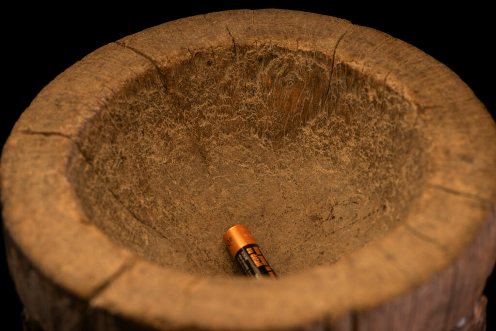 Small ancient mortar from the Paiwan tribe, richly carved around its circumference with a chain of crouching Paiwan figures.