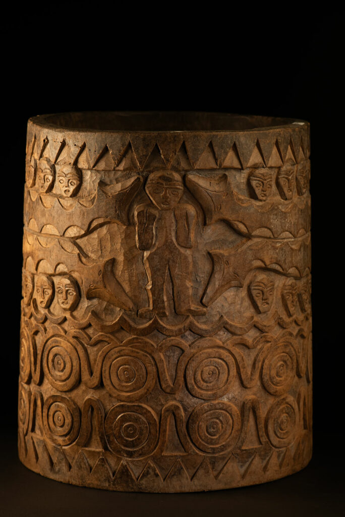 Ancient granary chest from the Paiwan tribe, used to store millet grains. Richly carved with sacred snakes, human heads, circular motifs, and anthropomorphic figures.