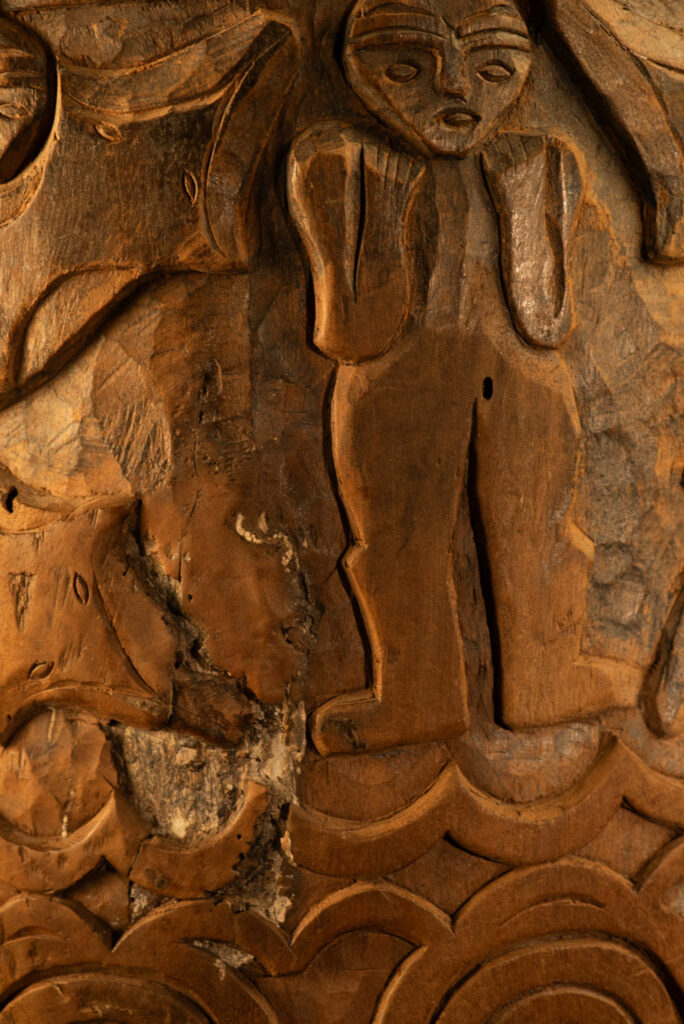 Ancient granary chest from the Paiwan tribe, used to store millet grains. Richly carved with sacred snakes, human heads, circular motifs, and anthropomorphic figures.