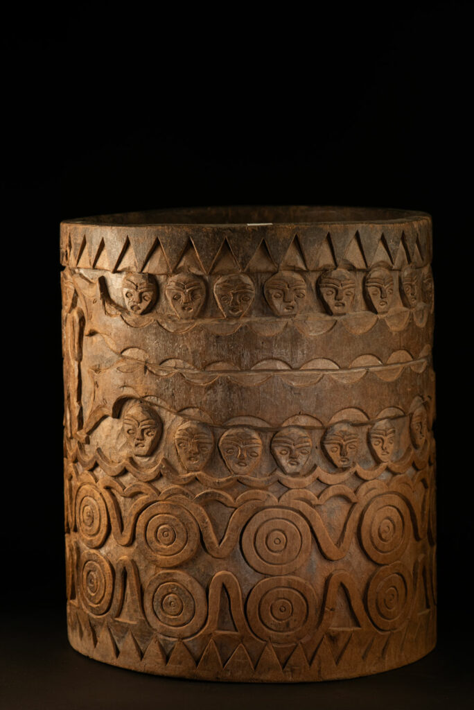 Ancient granary chest from the Paiwan tribe, used to store millet grains. Richly carved with sacred snakes, human heads, circular motifs, and anthropomorphic figures.