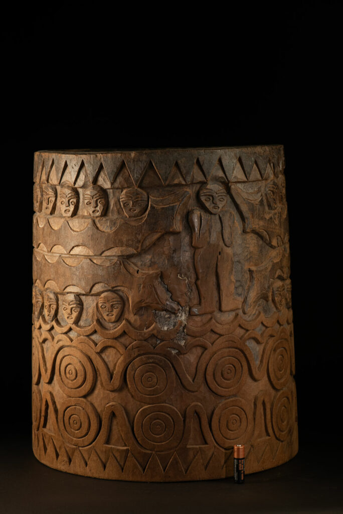 Ancient granary chest from the Paiwan tribe, used to store millet grains. Richly carved with sacred snakes, human heads, circular motifs, and anthropomorphic figures.