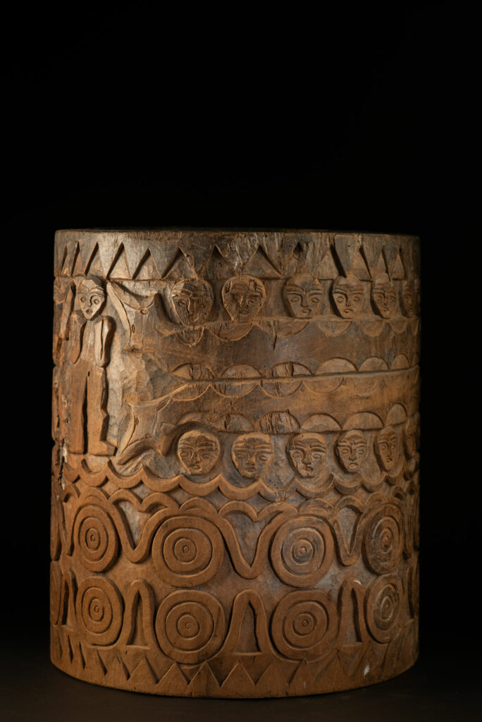 Ancient granary chest from the Paiwan tribe, used to store millet grains. Richly carved with sacred snakes, human heads, circular motifs, and anthropomorphic figures.